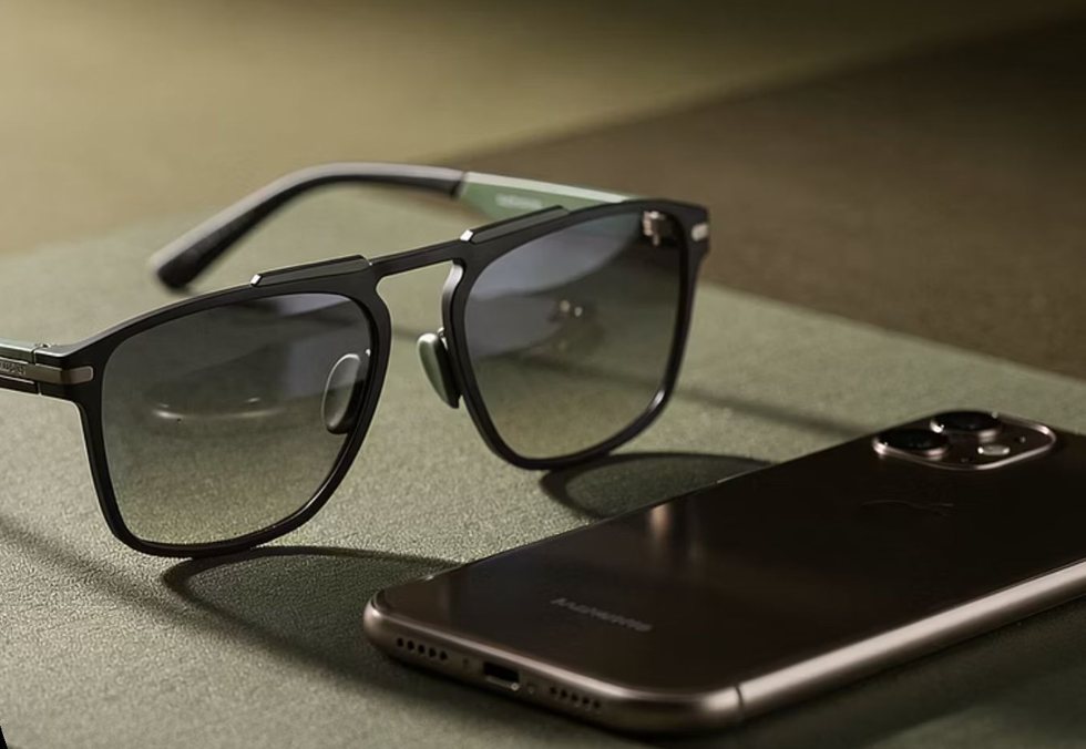A pair of lightweight Hearth sunglasses resting beside a phone